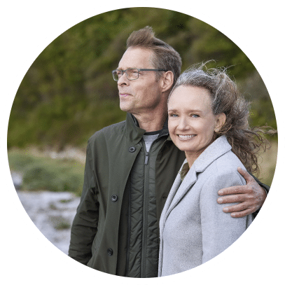 Happy mature couple using Oticon Real hearing aids