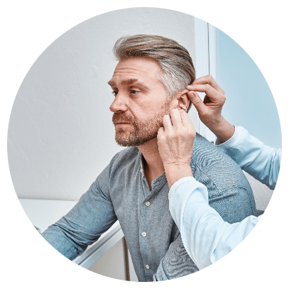 Mature man getting his hearing aids fitted